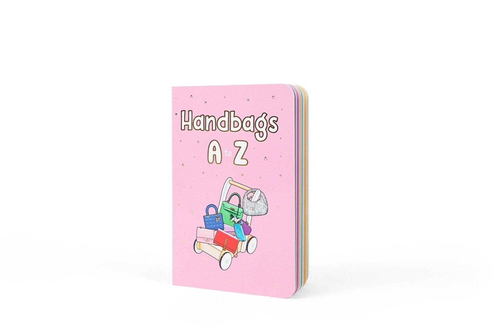 Cover image of the "Handbags A to Z" book in pink, showcasing an illustrated stroller filled with designer handbags and purses. A playful, stylish approach to learn about fashion brands for little boys and girls. The perfect kids stocking stuffer.